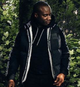 Nathan Palmer in Perverse Demand's Black Feather and Down Sherpa Lined Gilet