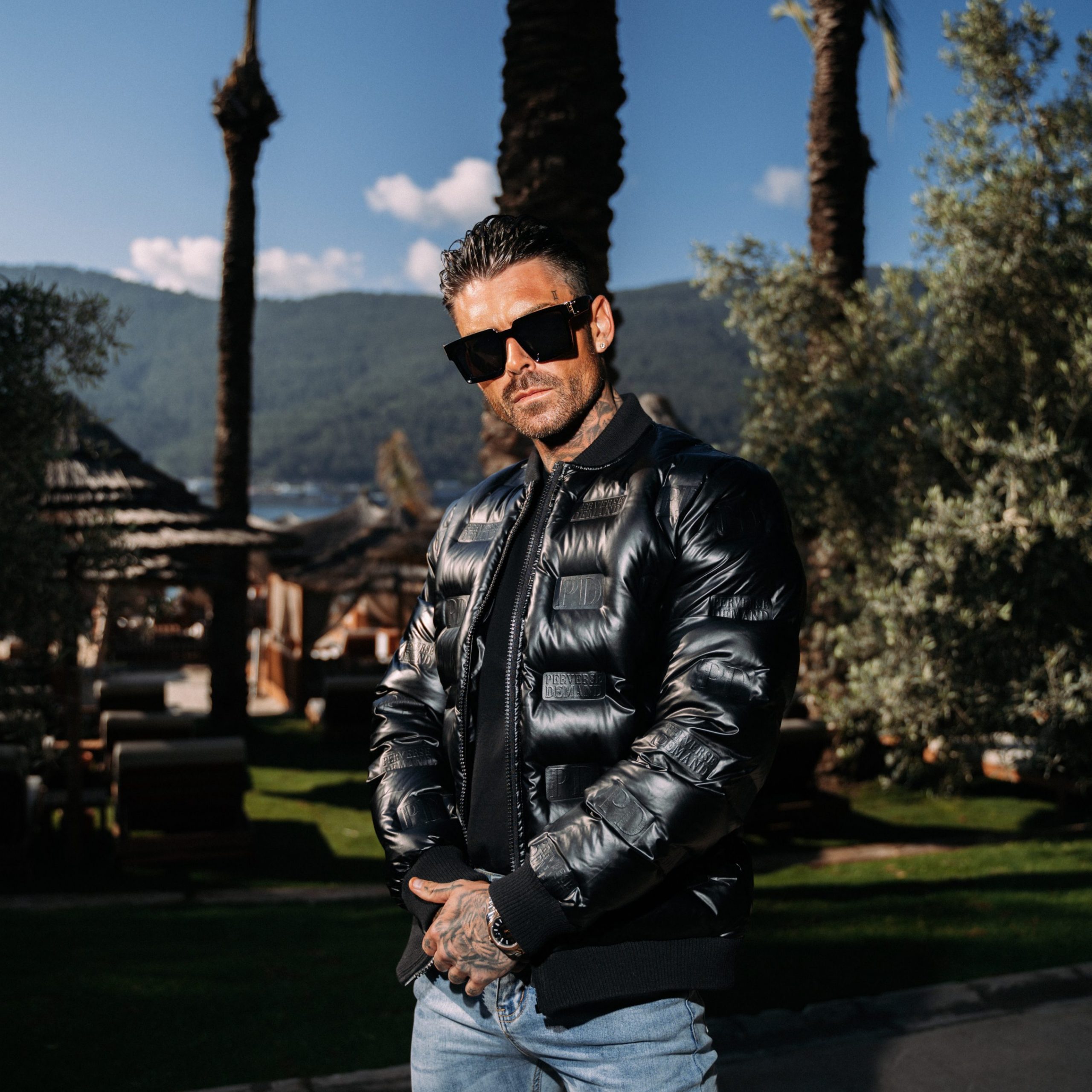 Robbie McMahon, influencer, modelling Perverse Demand's designer embossed jacket.